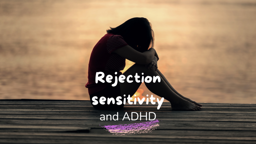 A young woman sitting alone on a wooden dock at sunset, hugging her knees. She appears sad, reflecting on rejection, symbolizing ADHD rejection sensitivity.